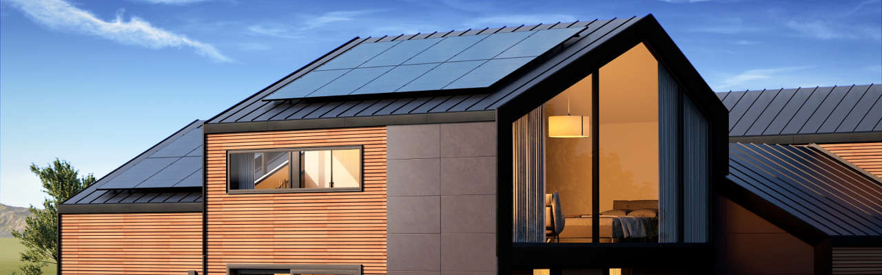 An image of a modern house with solar panel arrays on the roof
