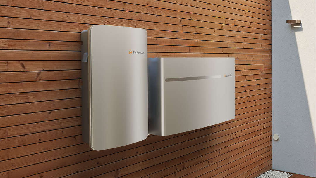 Emphase solar battery storage mounted on a wooden exterior wall